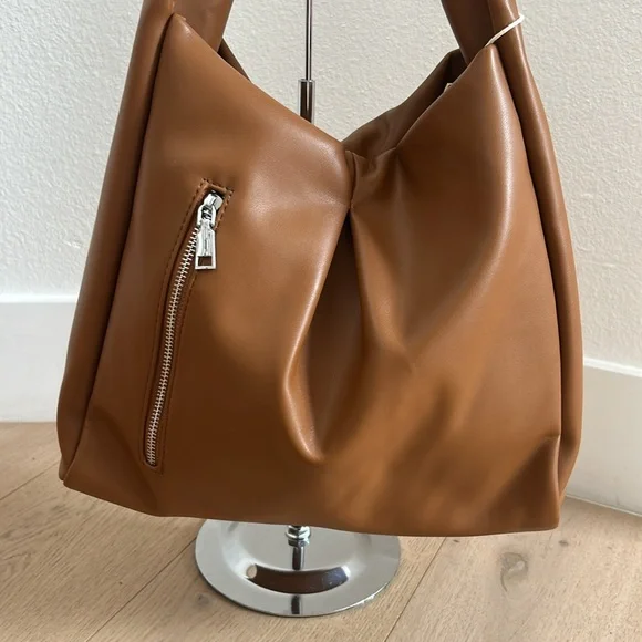 Tan bag with silver zipper in front of - Picture 2 of 5